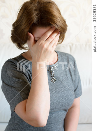 Woman covering her face with her hand. Depression Woman covering her face with her hand. Depression 35629581
