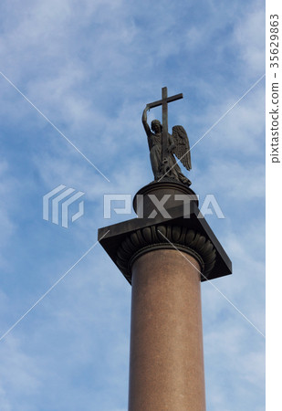 Angel with cross against cloudy blue sky Angel with cross against cloudy blue sky 35629863