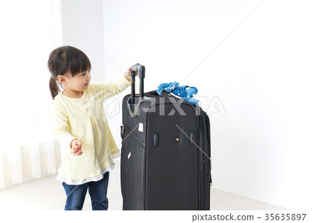 Child carrying a suitcase Child carrying a suitcase 35635897