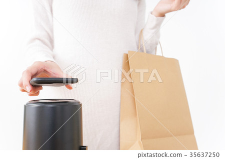 Young woman making a payment on a smartphone Young woman making a payment on a smartphone 35637250
