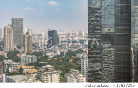 High building in foreground  and blurred cityscape on background 35637299