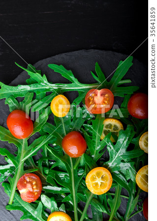 Vegetarian arugula salad with kumquat and tomato Vegetarian arugula salad with kumquat and tomato 35641859