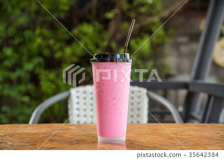 Thai style iced pink sweet milk in coffee shop Thai style iced pink sweet milk in coffee shop 35642384