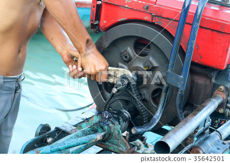 Men are repairing engines adapted for boats Men are repairing engines adapted for boats 35642501