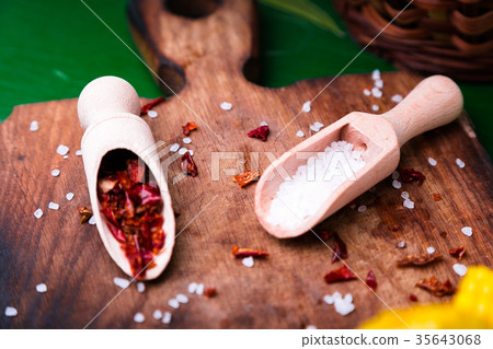 Sea salt and red dried pepper in a spoon 35643068