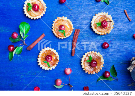 Apple caramel little tarts on blue rustic 35643127