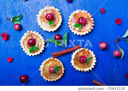 Apple caramel little tarts on blue rusti 35643128