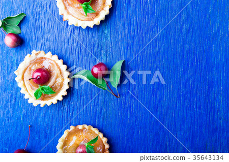 Apple caramel little tarts on blue rustic 35643134