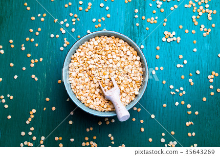 Dry yellow pea in green bowl on green background Dry yellow pea in green bowl on green background 35643269