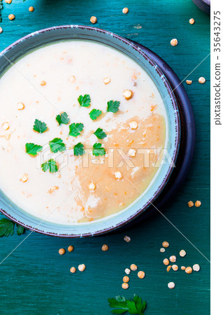 Pea soup in green bowl on green wooden Pea soup in green bowl on green wooden 35643275