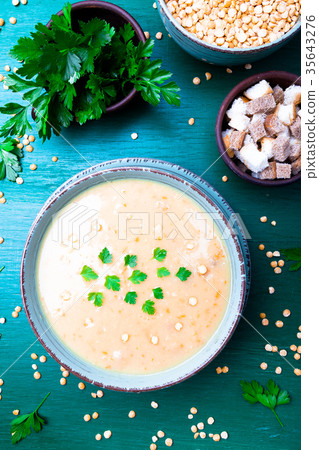 Pea soup in green bowl on green wooden Pea soup in green bowl on green wooden 35643276