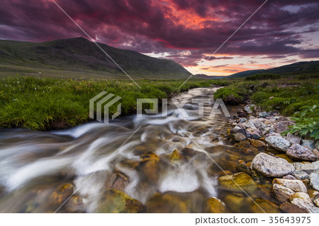 Beautiful sunset over the mountain river in summer Beautiful sunset over the mountain river in summer 35643975