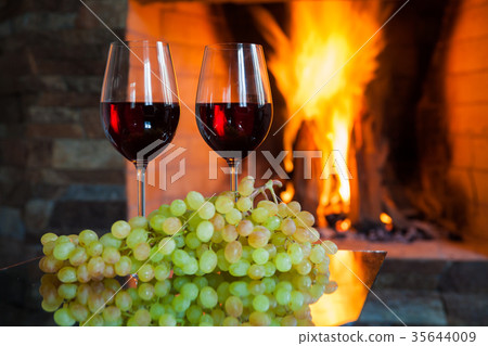Two glasses of red wine on the background of fire Two glasses of red wine on the background of fire 35644009