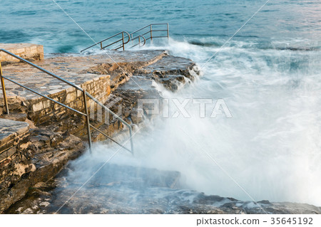 Swim ladder leading to stormy mystic sea 35645192