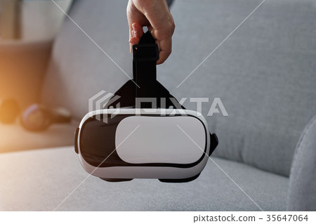 Man holding virtual reality goggle Man holding virtual reality goggle 35647064