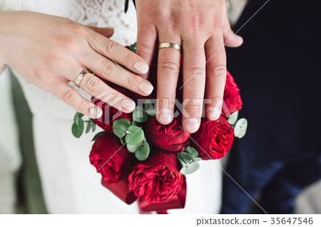 Detail of bride's bouquet and hands holding 35647546