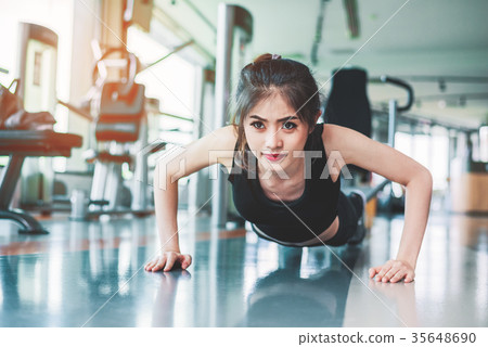 Asian woman fitness girl pushi up at fitness gym Asian woman fitness girl pushi up at fitness gym 35648690