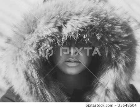 Beautiful girl in a hood with fur of a winter jack Beautiful girl in a hood with fur of a winter jack 35649604