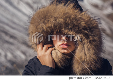 Beautiful girl in a hood with fur  35649608
