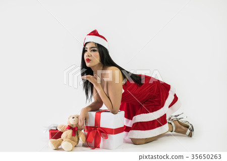 Beautiful happy woman in sexy Santa Claus clothes. Beautiful happy woman in sexy Santa Claus clothes. 35650263