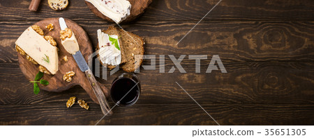 Assorted cheeses on wooden board Assorted cheeses on wooden board 35651305