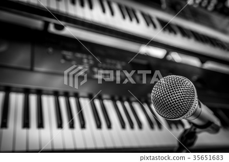 Microphone and Headphones on dirty sound mixer panel Microphone and Headphones on dirty sound mixer panel 35651683