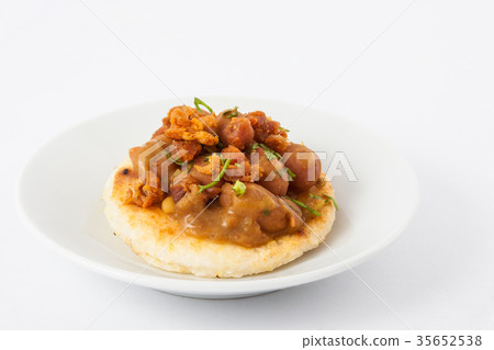 Colombian arepa topped with beans and pork rind Colombian arepa topped with beans and pork rind 35652538