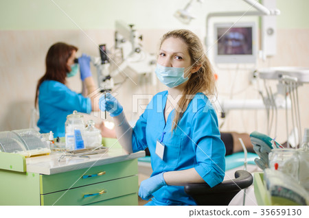 Portrait of young woman dentist assistant holding dental tool 35659130