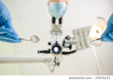 Doctor with a microscope in a dental clinic 35659255