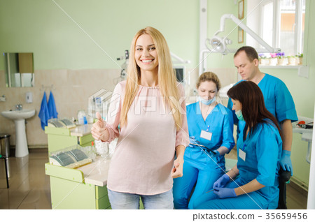Female patien with three doctors at the dental office Female patien with three doctors at the dental office 35659456