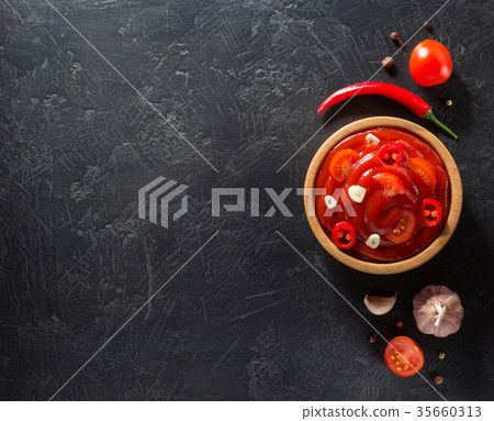 tomato sauce in bowl on black background tomato sauce in bowl on black background 35660313