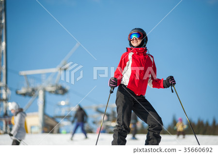Woman skier with ski at winer resort in sunny day 35660692