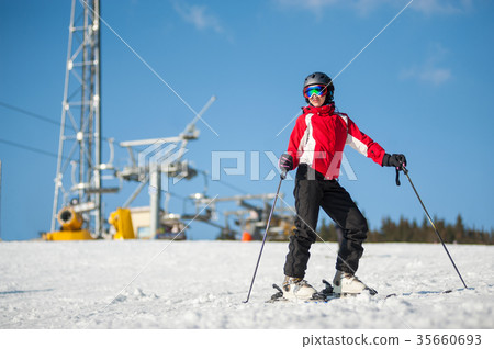 Woman skier with ski at winer resort in sunny day 35660693