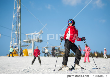 Woman skier with ski at winer resort in sunny day 35660694
