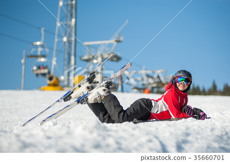 Woman skier with ski at winer resort in sunny day 35660701