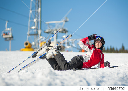 Woman skier with ski at winer resort in sunny day 35660702