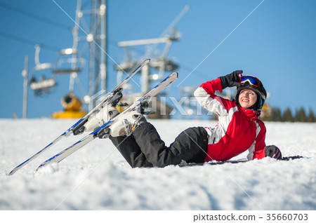 Woman skier with ski at winer resort in sunny day 35660703