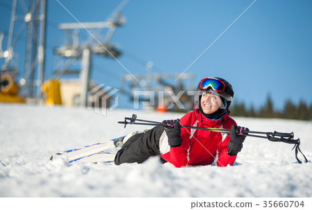 Woman skier with ski at winer resort in sunny day 35660704