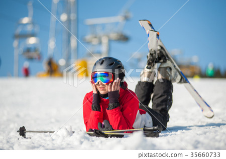 Woman skier with ski at winer resort in sunny day 35660733