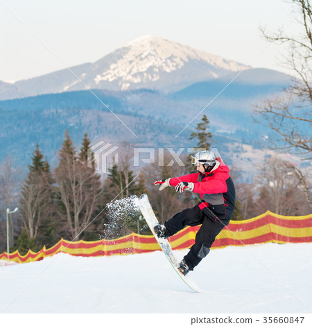 Male boarder on his snowboard at winer resort Male boarder on his snowboard at winer resort 35660847