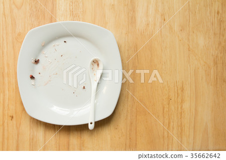 Dirty white plate and spoon with food scrap Dirty white plate and spoon with food scrap 35662642