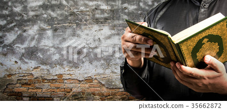 Koran in hand - holy book of Muslims Koran in hand - holy book of Muslims 35662872