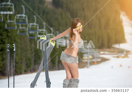 Sexy woman skier on snowy slope at ski resort Sexy woman skier on snowy slope at ski resort 35663137