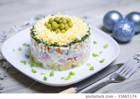 Traditional Russian salad olivier on a white plate 35665174
