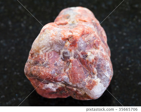 pebble of Pegmatite stone on dark background pebble of Pegmatite stone on dark background 35665706