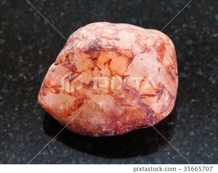 pebble of quartz stone on dark background pebble of quartz stone on dark background 35665707