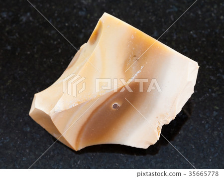 rough brown Flint stone on dark background 35665778