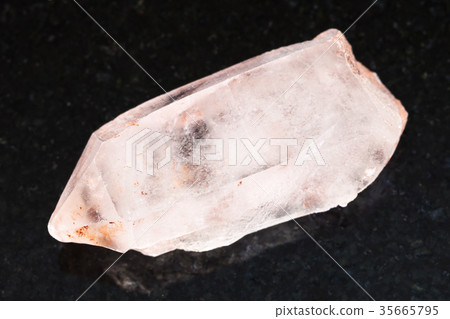 rough crystal of rose quartz gemstone on dark 35665795