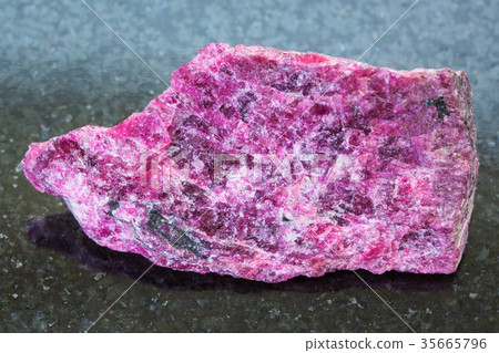 rough Eudialyte stone on dark background 35665796