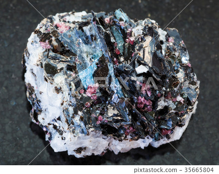 rough Gneiss stone with crystals on dark rough Gneiss stone with crystals on dark 35665804